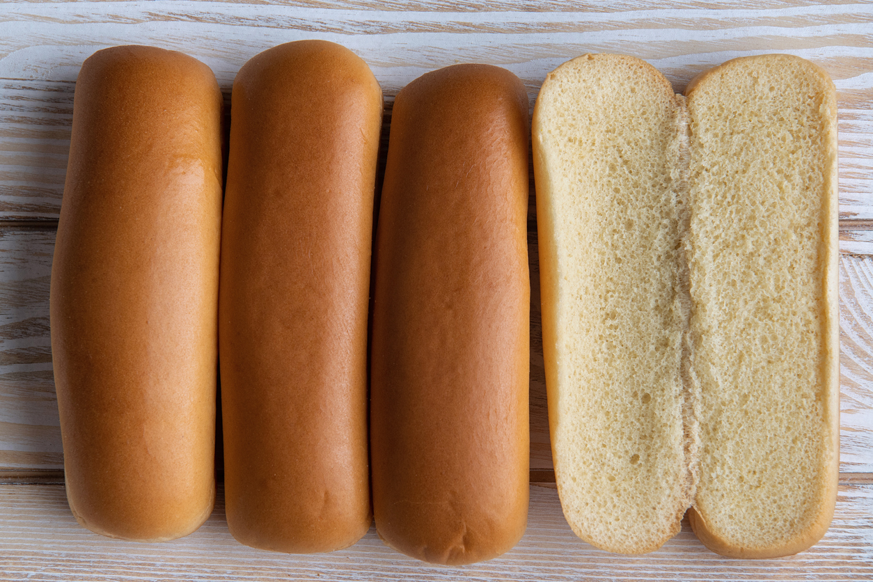 Hotdog buns from above over a wooden surface