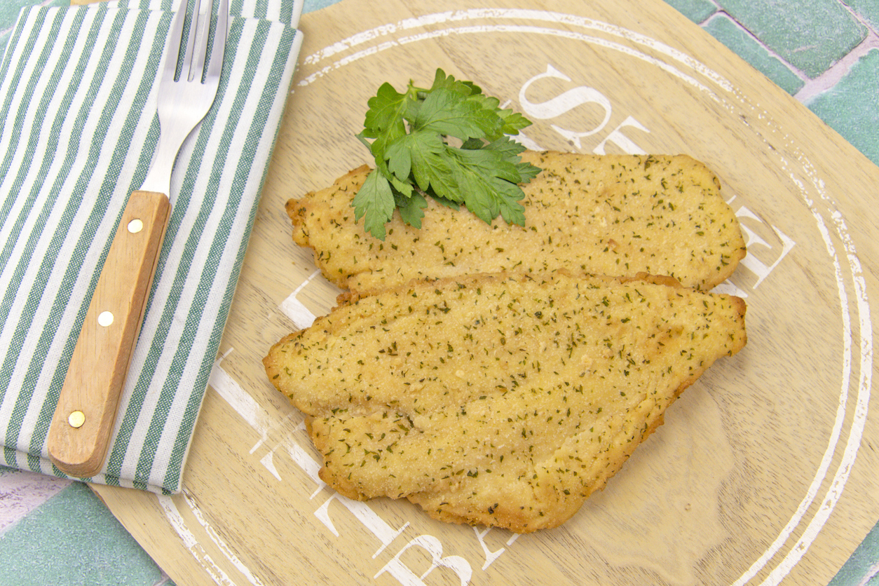 breaded fish on a breaded fish board on a white background