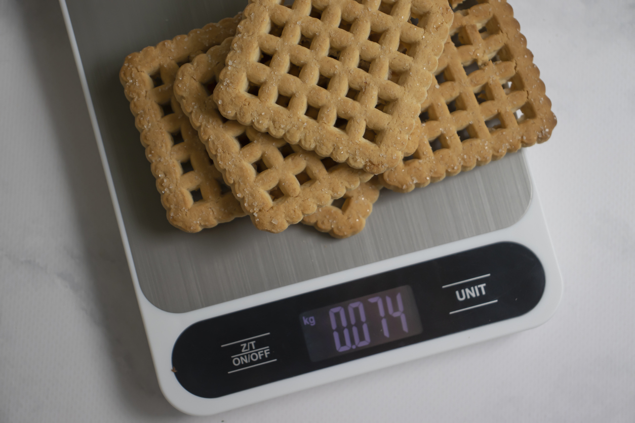 Cookies, kitchen scales on a light background