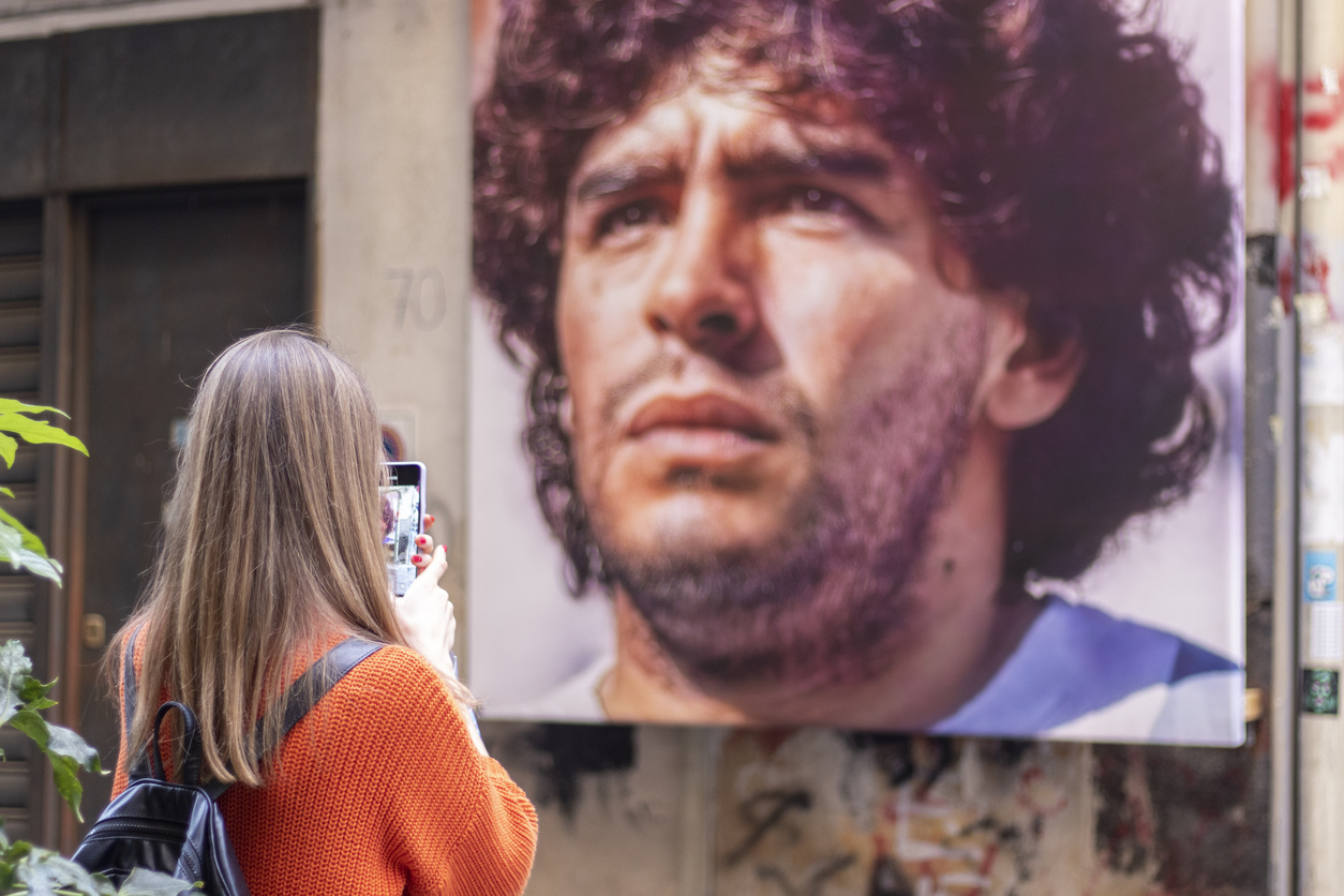 Naples, Italy - November 7, 2021. Tourist on the streets of Naples. Quartieri Spagnoli. Portrait of Diego Armando Maradona.